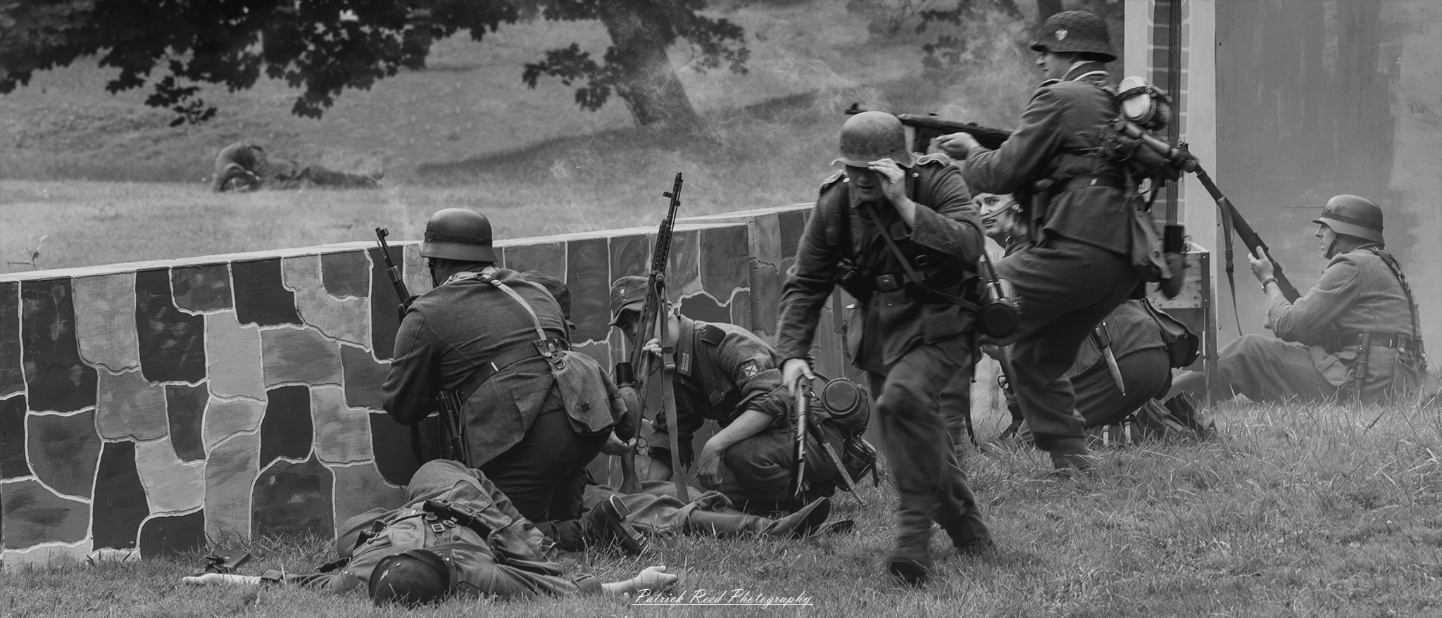 German soldiers crouched behind a wall, their faces tense as they take cover. The scene conveys the anticipation and caution of soldiers preparing for the next move, highlighting the intensity and strategic nature of warfare.